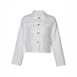 Detail of white quilted jacket featuring silver buttons and textured lapel collar