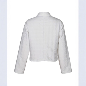 Rear view of white quilted jacket with diamond pattern and long sleeves for women