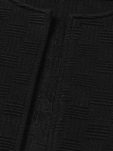Detailed close-up of high-quality black fabric with textured grid weaving on the collar