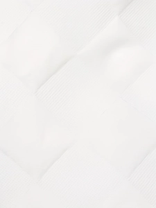 Macro shot of white jacquard fabric with elegant diamond pattern weaving texture