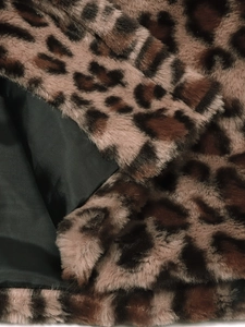 Detail of leopard print faux fur texture and smooth black satin lining on fashion jacket