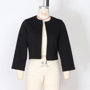 Detail of black cropped jacket with textured waffle knit fabric and three-quarter sleeves