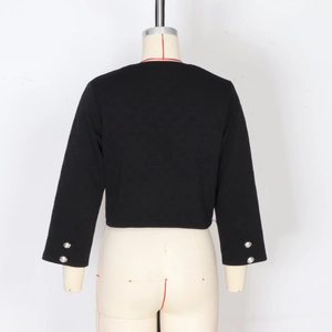 Close-up of black jacket sleeves with detailed silver metal buttons and textured fabric