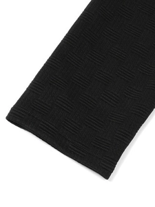 Detail of black jacket cuff with textured knit pattern and durable double-stitch seams