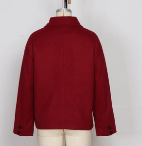Detailed back view of dark red wool blend jacket featuring lapel and buttoned cuffs