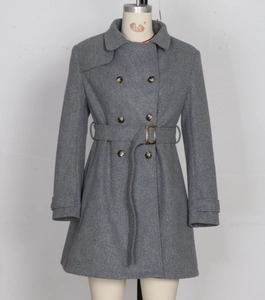 Detail of grey double-breasted wool coat featuring a matching waist belt and classic lapels