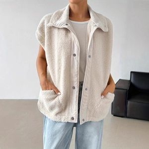Detail of off-white sherpa fleece vest featuring a high collar and snap button closures