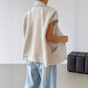 Detail of oatmeal sherpa vest with cozy textured fabric and relaxed fit cut
