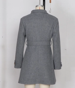 Rear view of long grey wool coat featuring slim fit tailoring and decorative waist belt