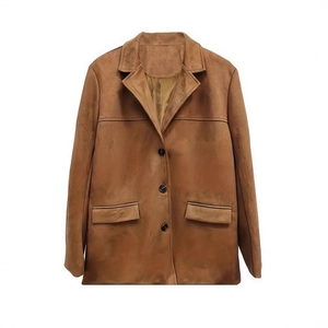 Detail of brown faux suede blazer featuring classic lapels and three-button closure