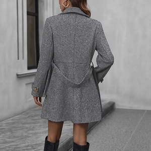 Rear view of grey wool coat showing waist belt tie and buckle detail on the sleeves