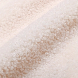 Close-up of soft white wool blend fabric texture on sleeveless winter vest jacket