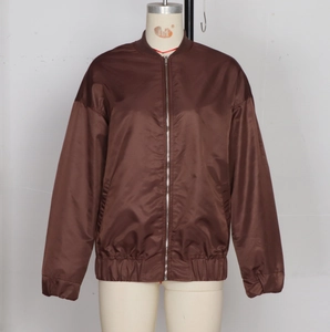 Detail of a brown satin bomber jacket showing a metallic zipper and a ribbed stand collar