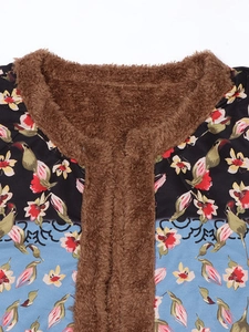 Detail of winter cardigan featuring brown faux fur lining and ethnic floral print patterns