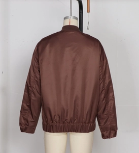 Back view of a vintage dark brown flight jacket on a mannequin with ribbed cuffs