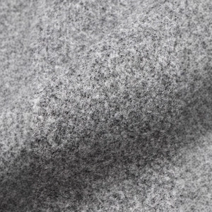Macro shot of gray wool fabric texture showing detailed fibers and thick warm material