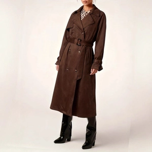 Detailed view of dark brown trench coat featuring double-breasted design and waist belt