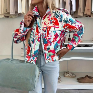 Detailed macro view of the colorful floral bird print and zip closure on the jacket