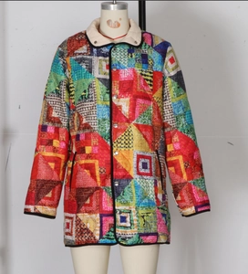 Detail of colorful geometric quilted jacket with contrast collar and silver metal buttons