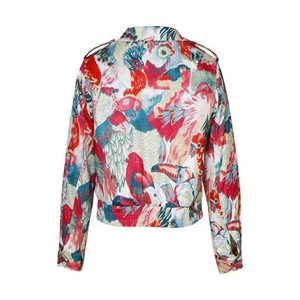 Detail view of floral jacket back showing tropical bird prints and elastic hemline