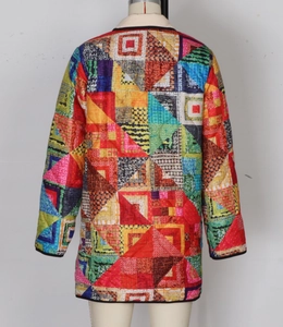 Detailed patchwork quilting and black edge stitching on a colorful quilted padded jacket