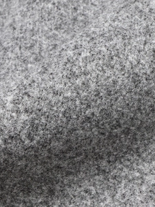 Close-up of high-quality dark grey wool blend fabric with rich texture for winter coat