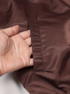 Women's dark brown thermal flight jacket with functional side pockets and smooth finish