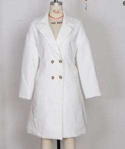 Detail view of double-breasted white wool coat with notched lapel and brown buttons