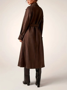Women's long brown trench coat with waist belt and adjustable cuffs for autumn