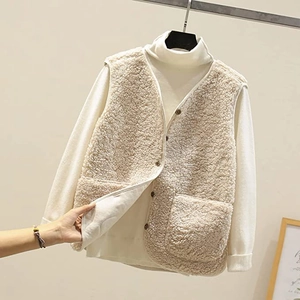 Detailed texture of beige faux lamb wool vest with vintage buttons and V-neckline