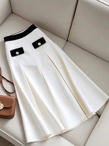 Elegant white A-line midi skirt with black high waist detail and decorative pockets