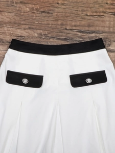 Women's high waist pleated midi skirt in black and white with silver metal buttons