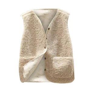 Close-up of beige faux shearling vest fabric showing curly texture and dark button details