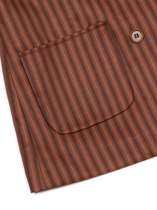 Close-up of a brown striped vintage blazer featuring fine stitching and button detail