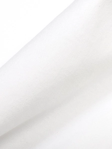 Detailed macro shot of white pleated fabric texture with elegant silk satin sheen