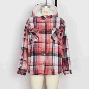 Detail of warm white fleece lining and red plaid pattern on hooded winter jacket