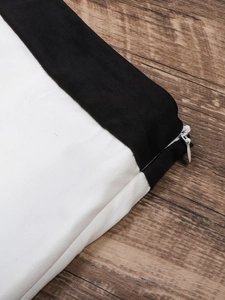 Detailed macro view showing the hidden white zipper and woven fabric texture of the skirt