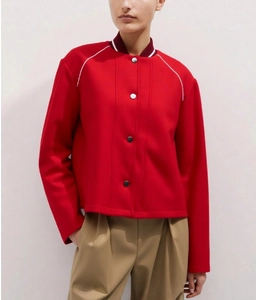 Close-up of red casual jacket featuring white piping on shoulders and metal snap buttons