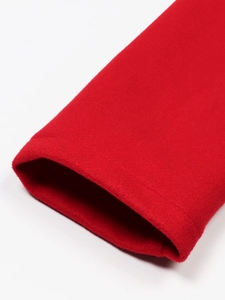 Detailed macro view of the premium red wool fabric sleeve and fine stitching on jacket