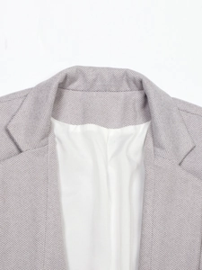 Close-up of lilac grey herringbone blazer featuring a classic lapel and premium woven fabric