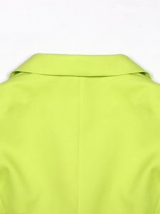 Close-up of the lime green blazer back collar with precise stitching and woven texture