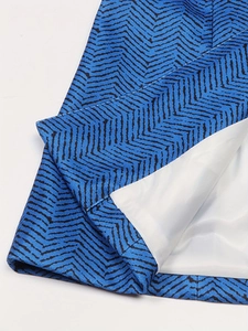 Detail shot of blue and black herringbone pattern blazer with white lining and neat stitching