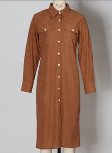 Detail of brown corduroy shirt dress featuring a classic collar and front button closure