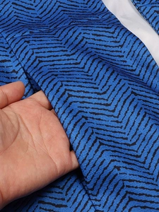 Close-up of the blue and black herringbone blazer pocket detail with white inner lining