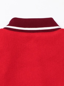 Detail of red wool jacket with striped rib-knit collar and premium stitching