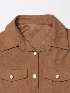 Close-up of brown corduroy shirt jacket featuring lapel collar and flap chest pockets