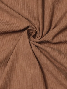 Close-up of premium brown corduroy fabric showing soft ribbed texture and draped material