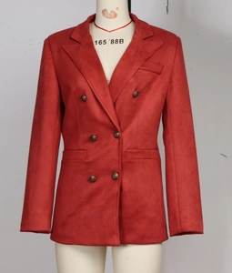 Detail of red double-breasted suede blazer featuring metallic buttons and flap pockets