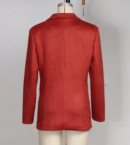Detail view of the back of a brick red suede blazer featuring professional tailored seams