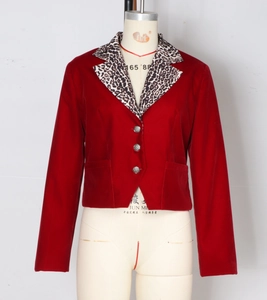 Detail of red blazer with leopard print lapels, velvet texture, and round buttons